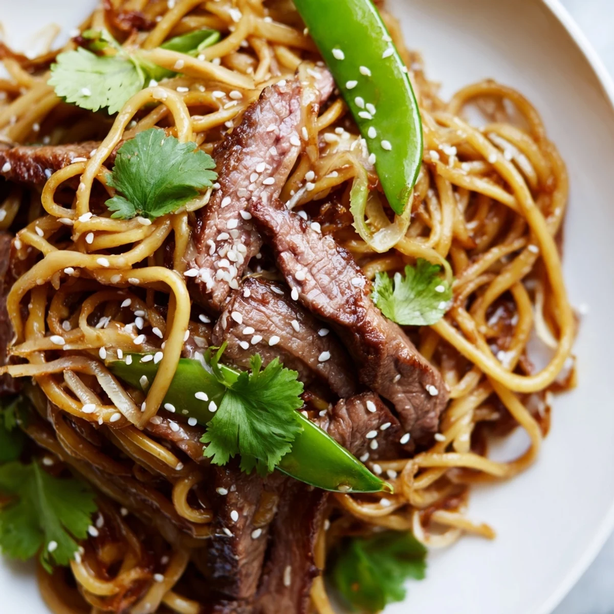 Garnished with fresh cilantro and spring onions, this Spicy Beef Noodles recipe is a perfect quick weeknight dinner.