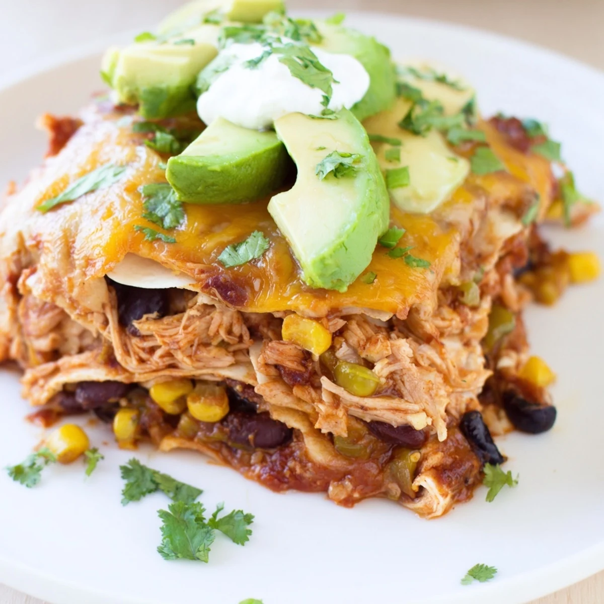 A hearty serving suggestion of Chicken Enchilada Casserole with Cheese, garnished with fresh cilantro.