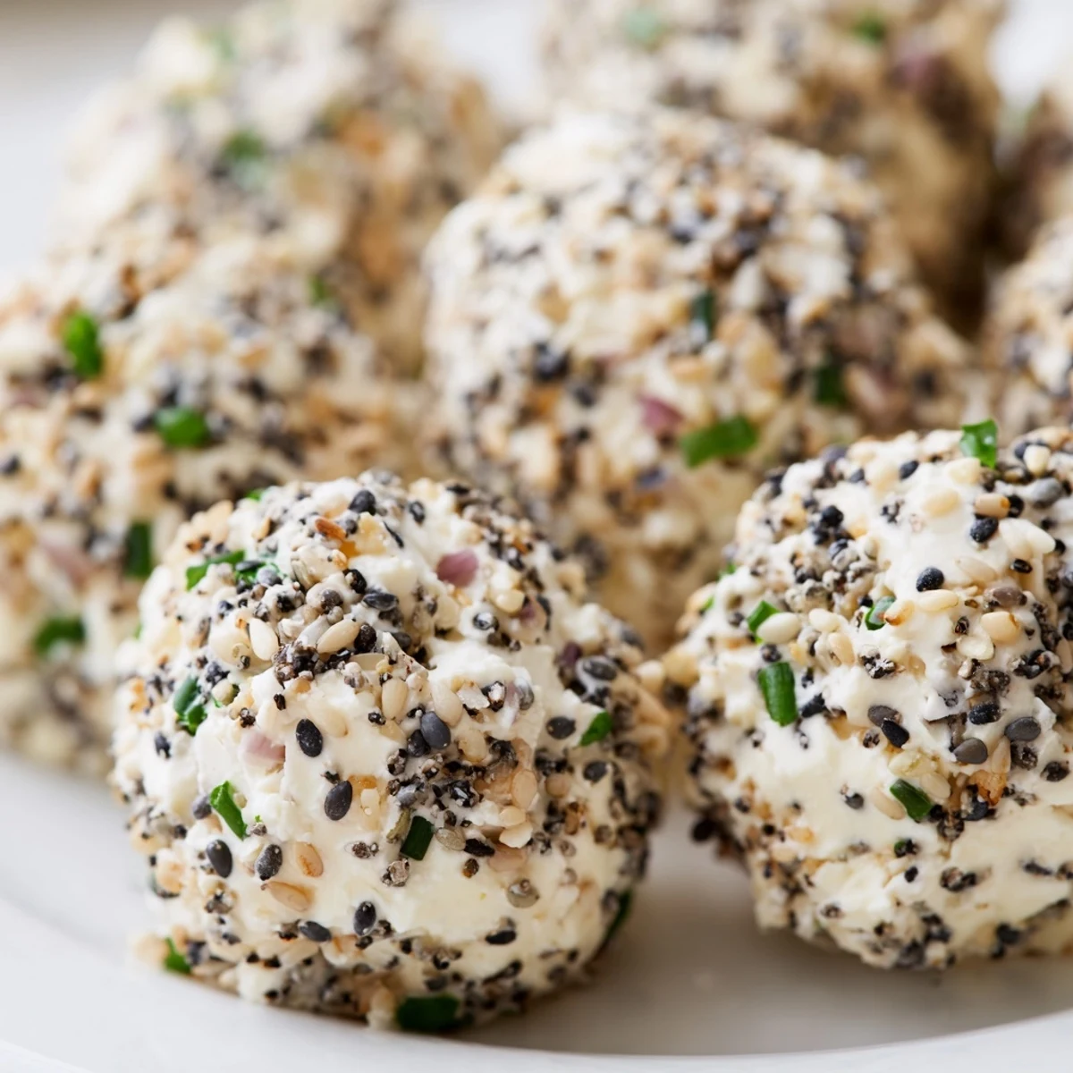 Savory Everything Bagel Cottage Cheese Bites served chilled with crisp cucumber slices and a sprinkle of everything seasoning.