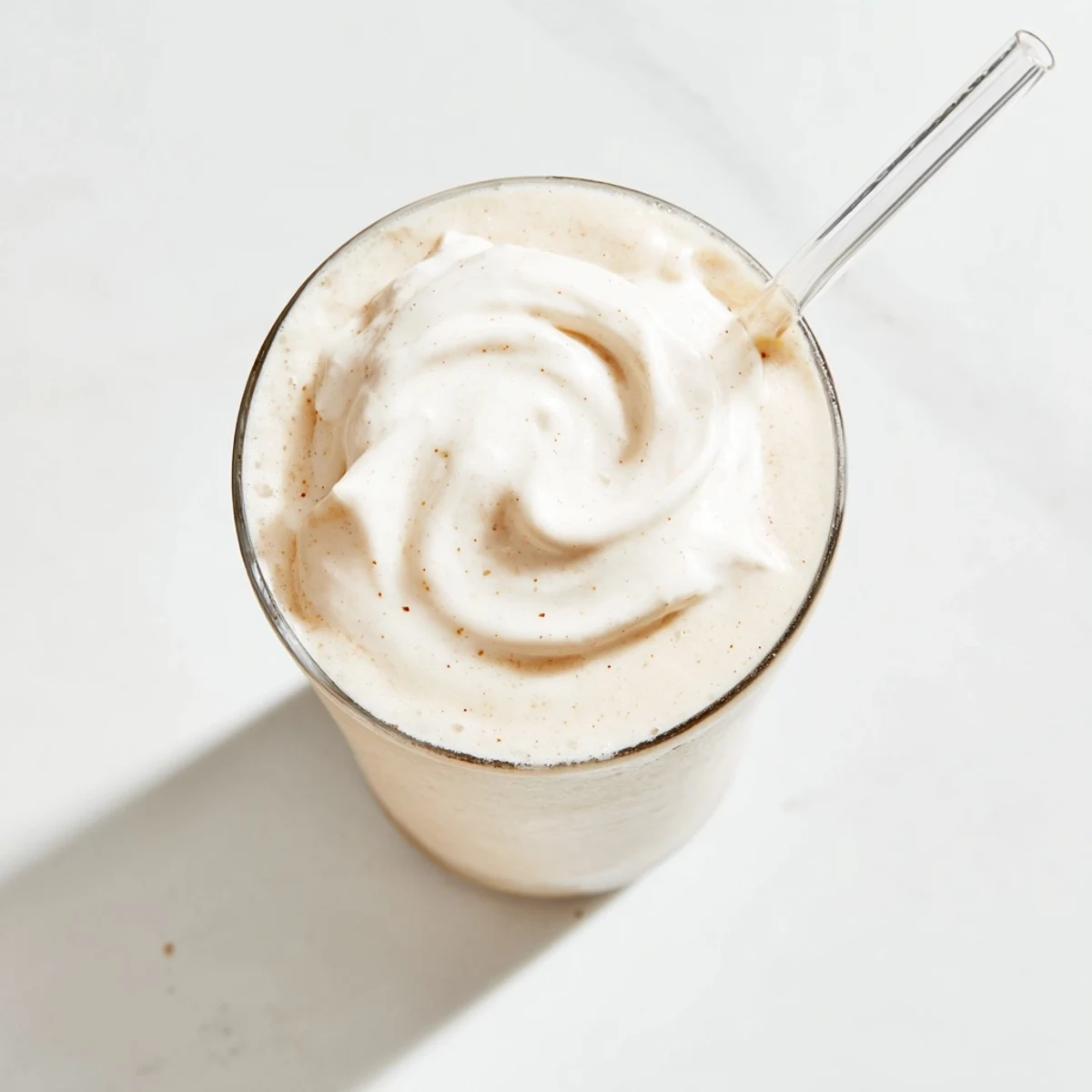 Cold Vanilla Bean Frappuccino topped with fluffy whipped cream, perfect for sipping on a warm American afternoon.