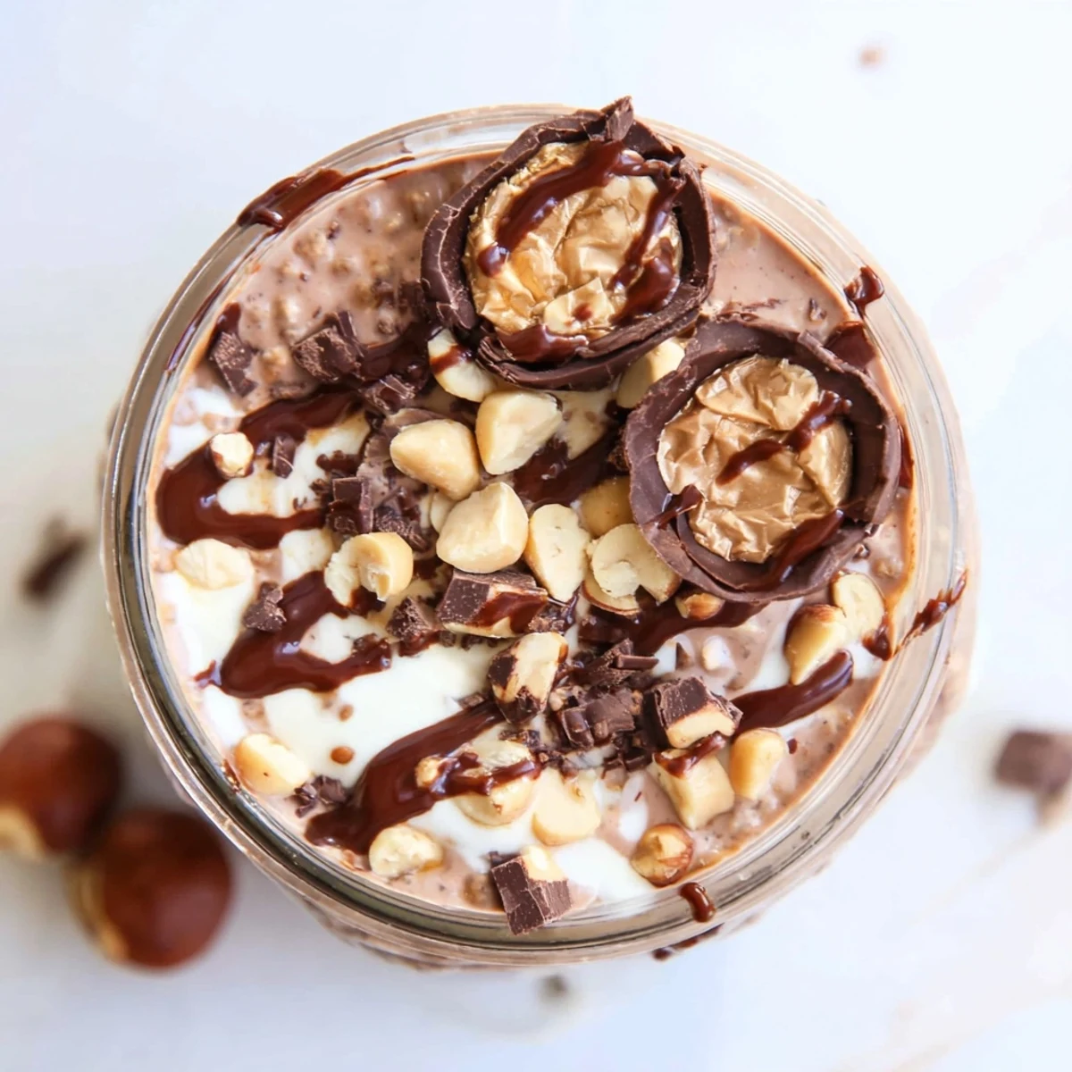 Decadent Ferrero Rocher Protein Overnight Oats with creamy hazelnut swirl, served chilled for an easy breakfast.