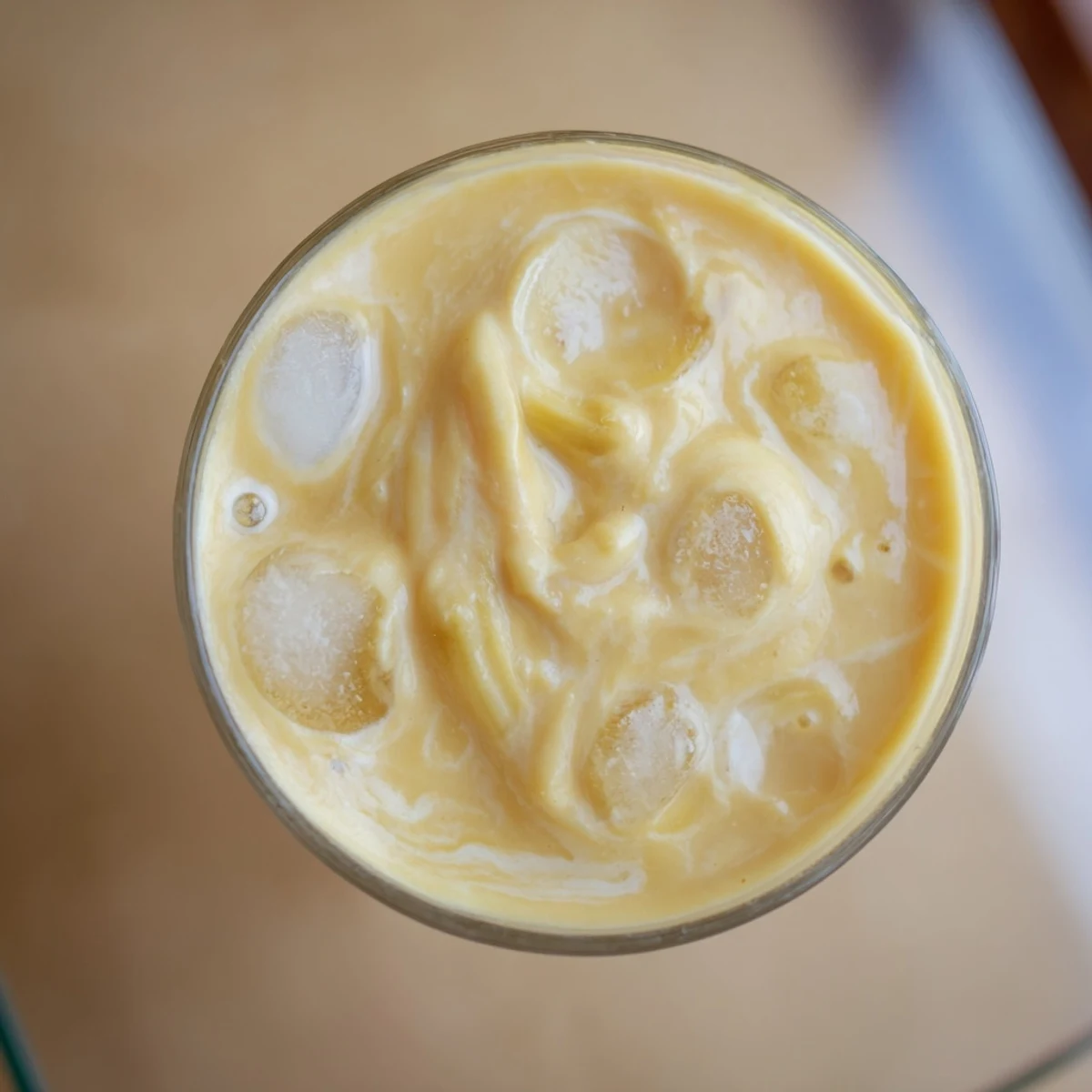 Creamy durian smoothie blended with ripe banana and coconut milk in a chilled glass