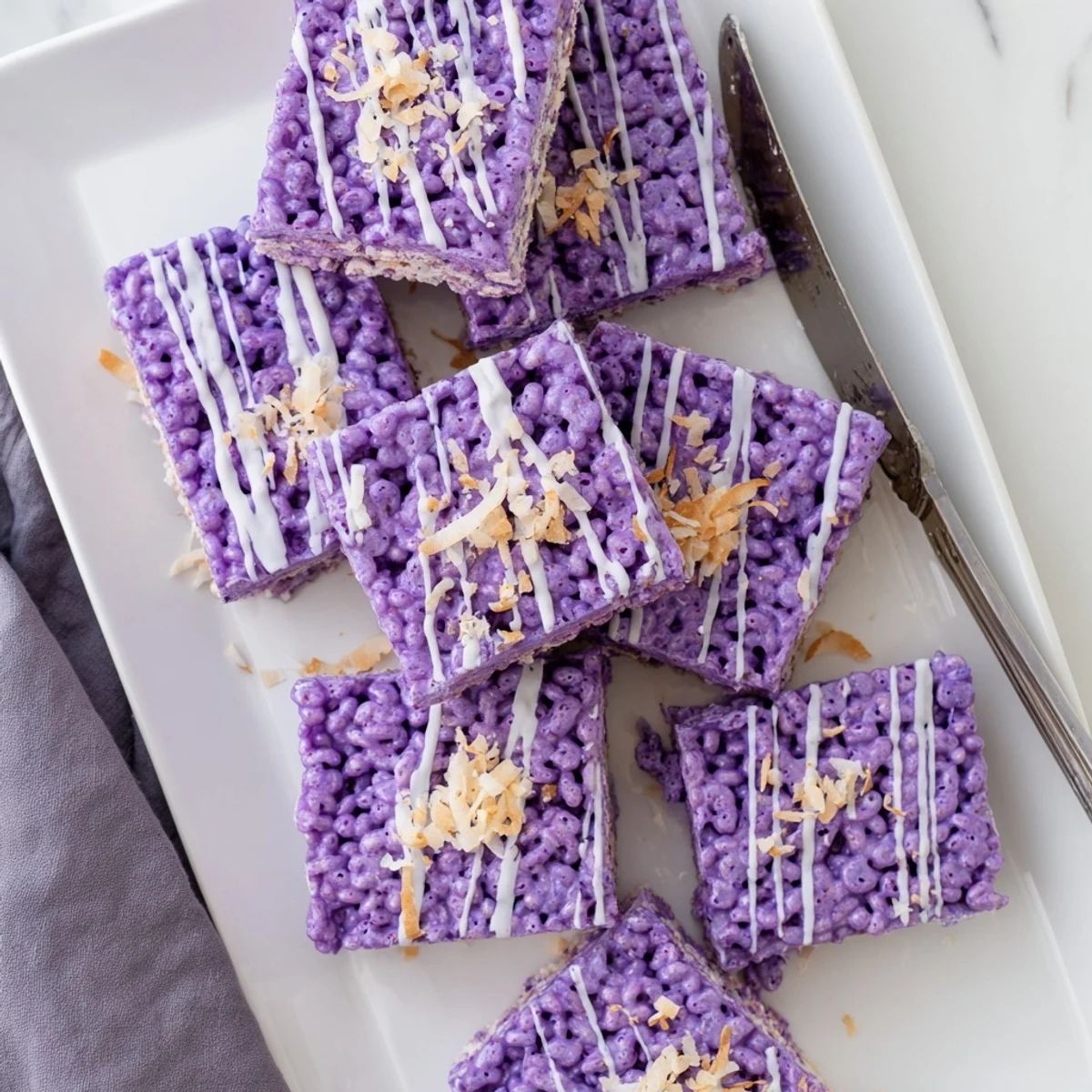 Chewy ube marshmallow squares pressed into a pan with vibrant purple color throughout