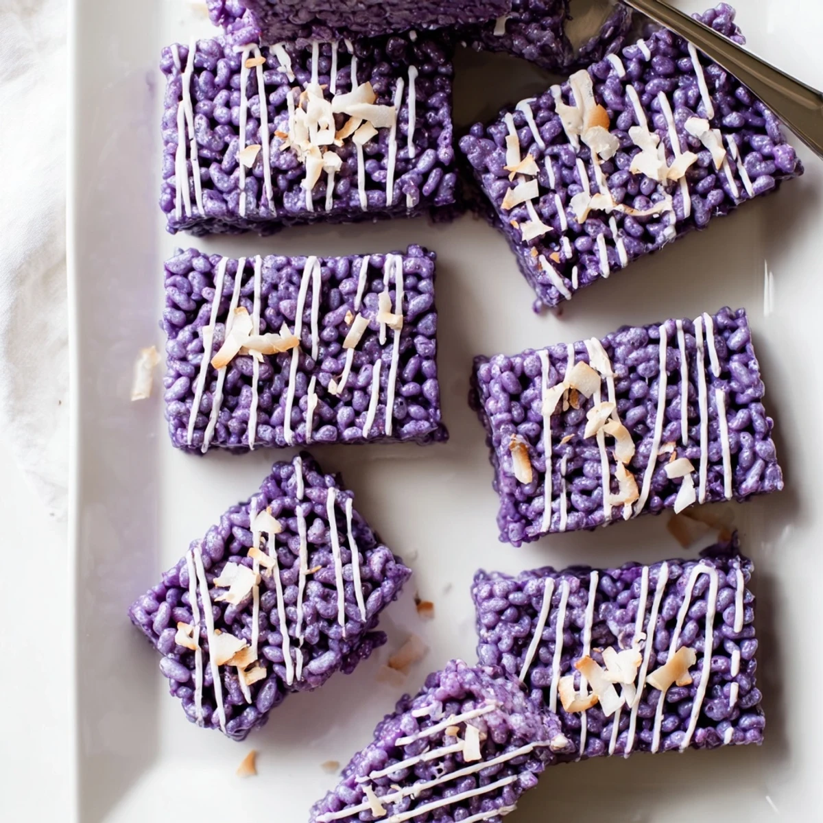 Purple Filipino yam rice cereal bars featuring creamy ube halaya and crispy rice puffs