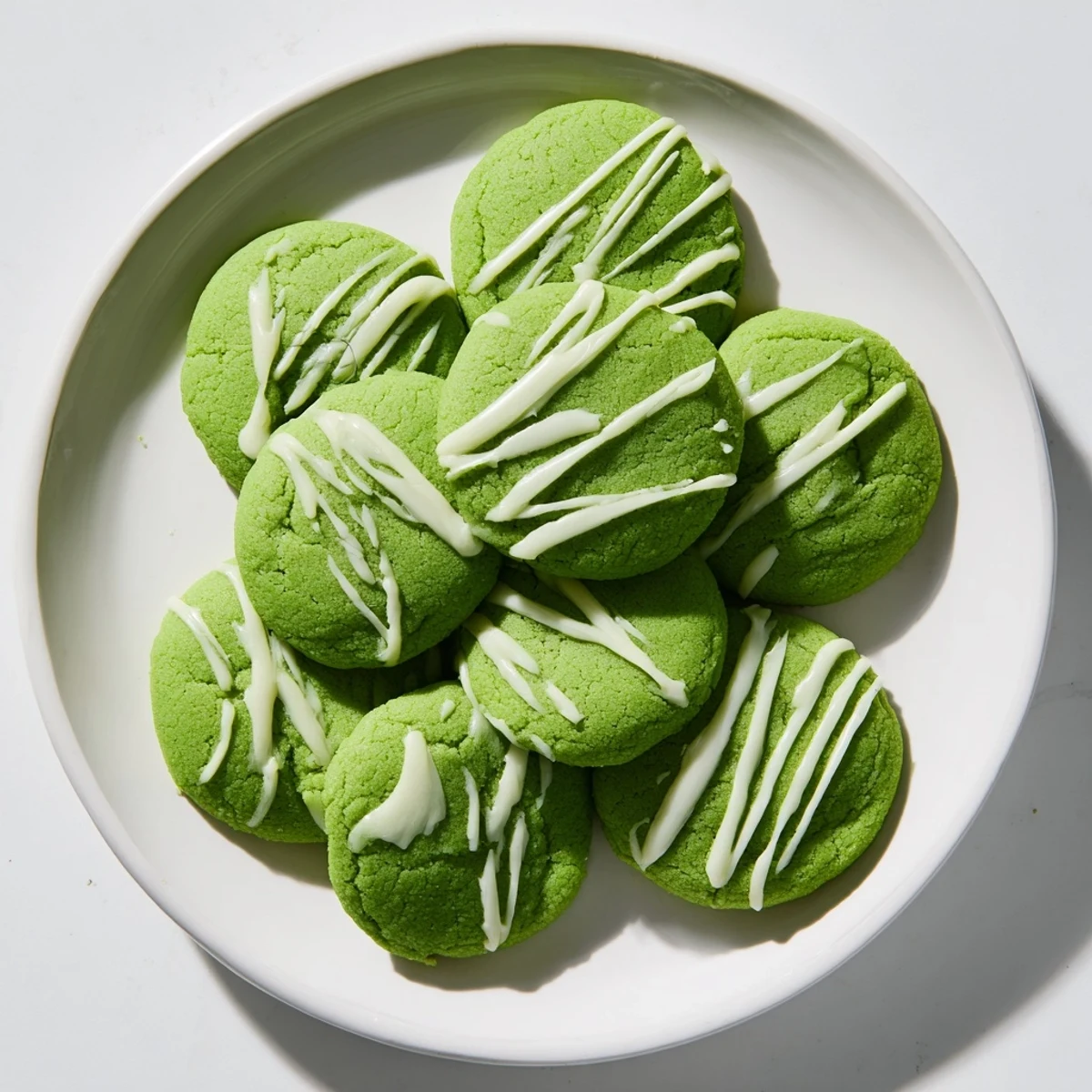 Vibrant green cookies with sweet white chocolate swirls baked to tender perfection