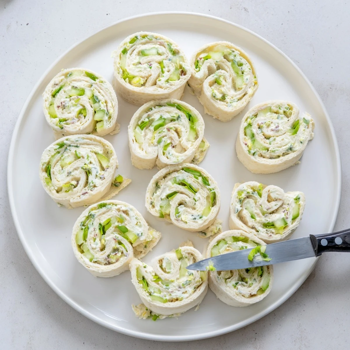 Pickle dip pinwheels featuring spirals of creamy herbed cheese with chopped dill pickles rolled inside soft flour tortillas