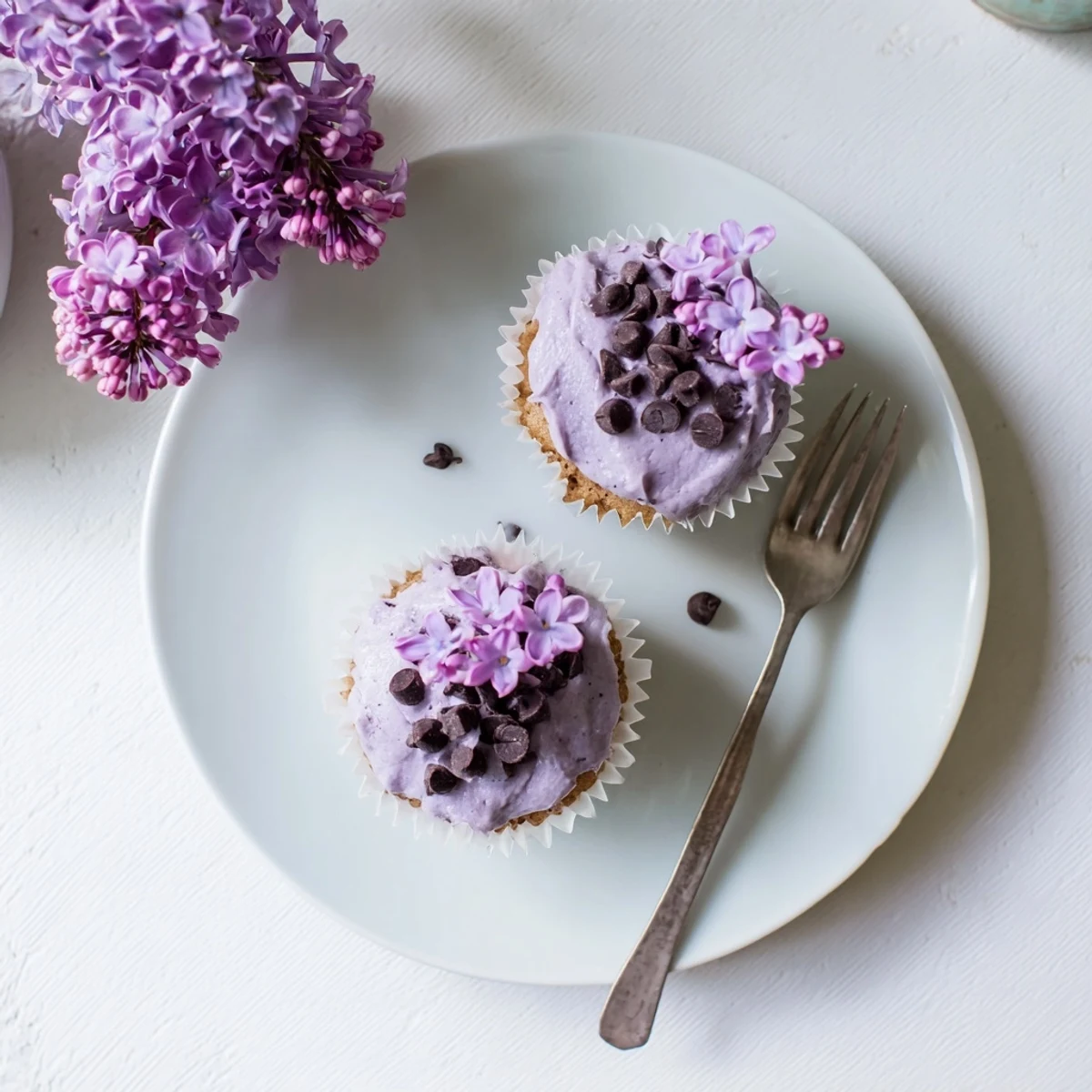 Small batch lilac chocolate cupcakes topped with floral buttercream and fresh purple blossoms
