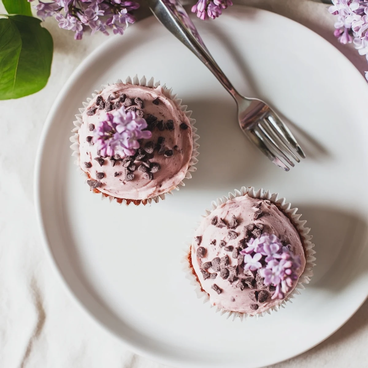 Moist chocolate lilac cupcakes decorated with silky frosting and edible flowers for spring