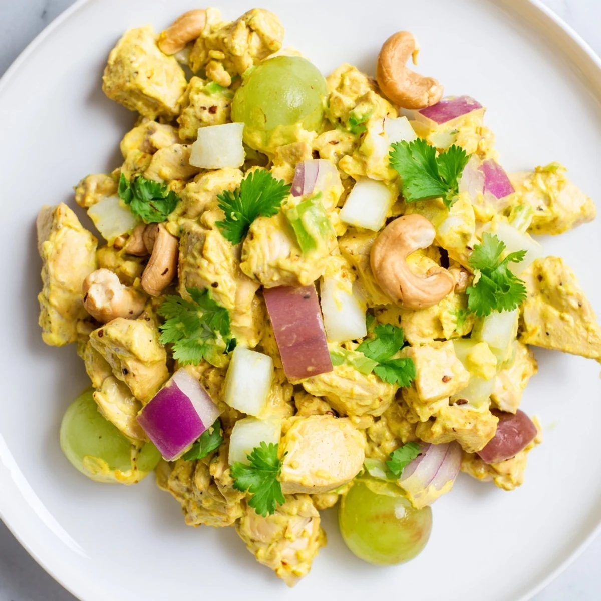 Creamy curry chicken salad loaded with diced apples, grapes, and crunchy toasted cashews