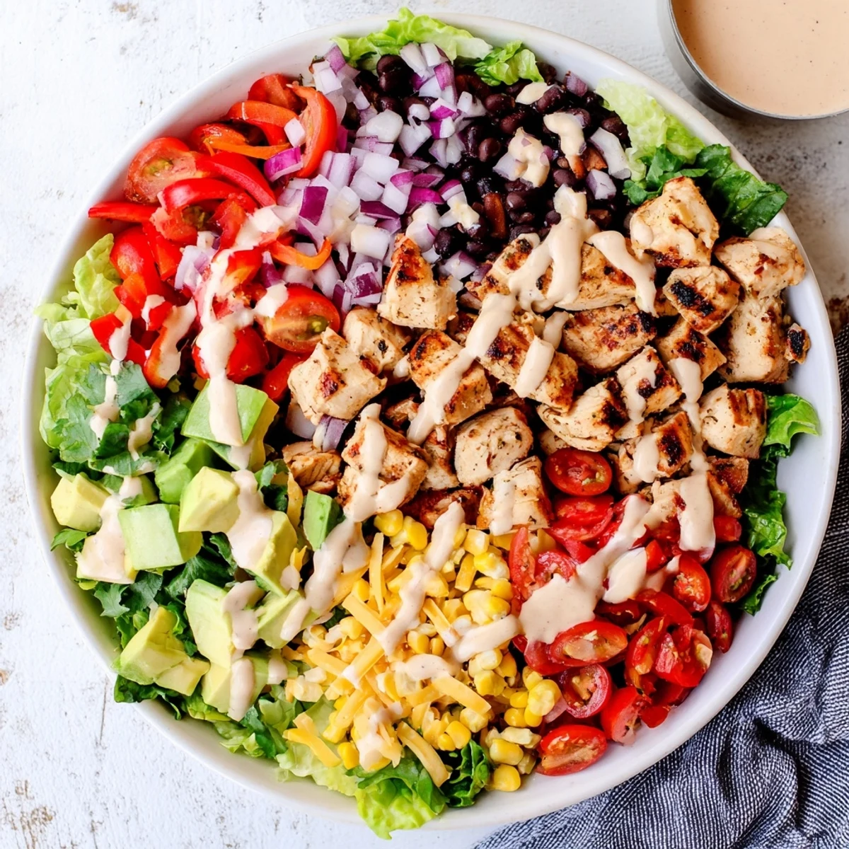 Protein-packed healthy BBQ chicken chopped salad featuring crisp vegetables, black beans, and tangy barbecue dressing
