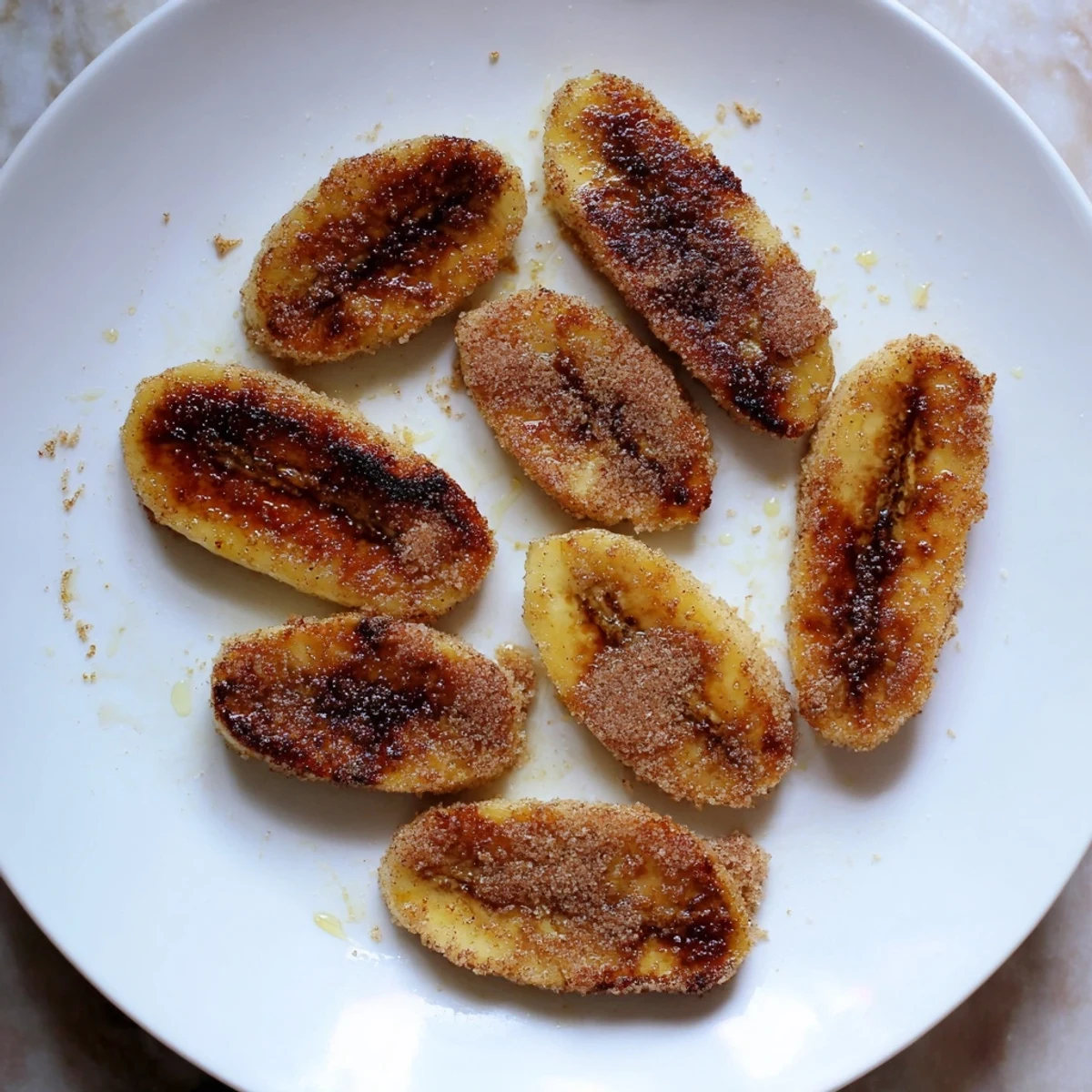 Sweet pan fried cinnamon bananas served warm with maple syrup drizzle on top