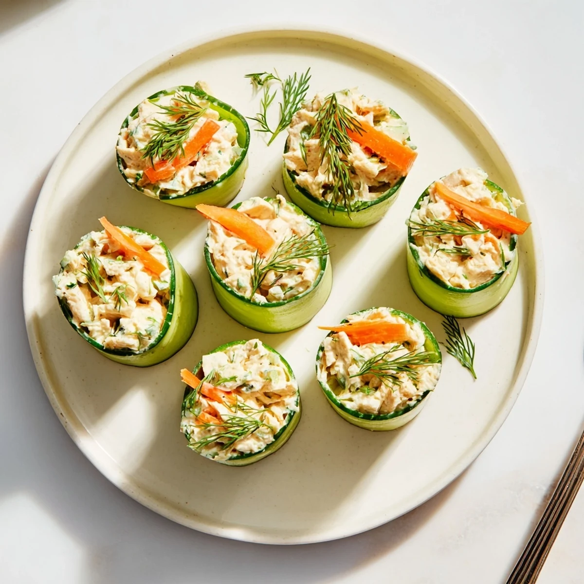 Crisp cucumber ribbons rolled around creamy chicken salad filling for an easy low-carb appetizer