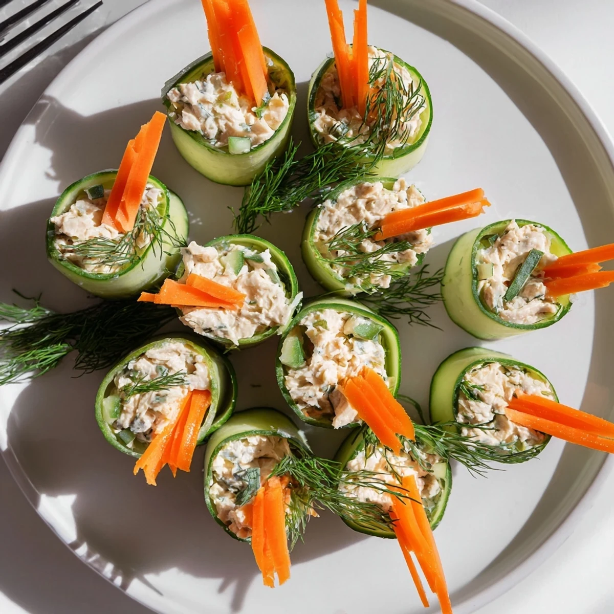Creamy chicken and vegetable salad wrapped in thin cucumber slices for a refreshing gluten-free lunch