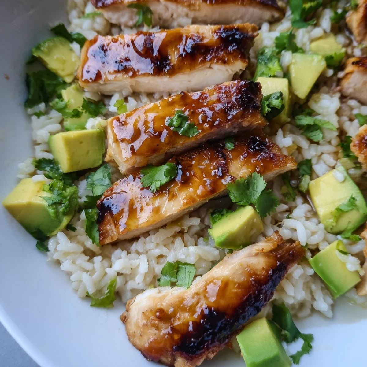 Juicy honey lime chicken sliced and served over creamy green avocado rice with fresh cilantro garnish