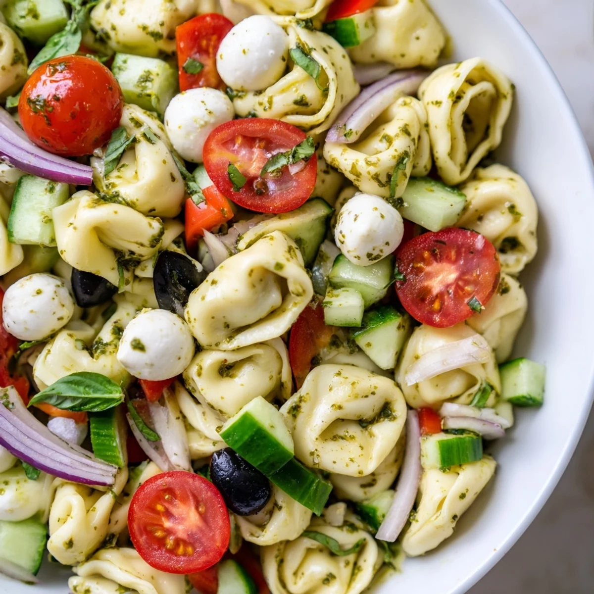 Cheese tortellini pasta salad tossed with crisp vegetables and zesty Italian dressing