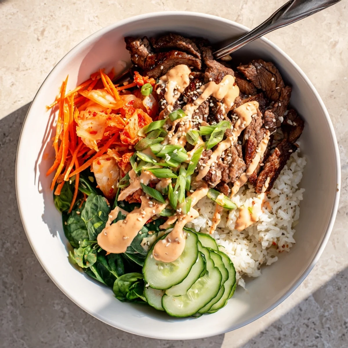 Korean BBQ steak rice bowls drizzled with spicy cream sauce over fluffy jasmine rice