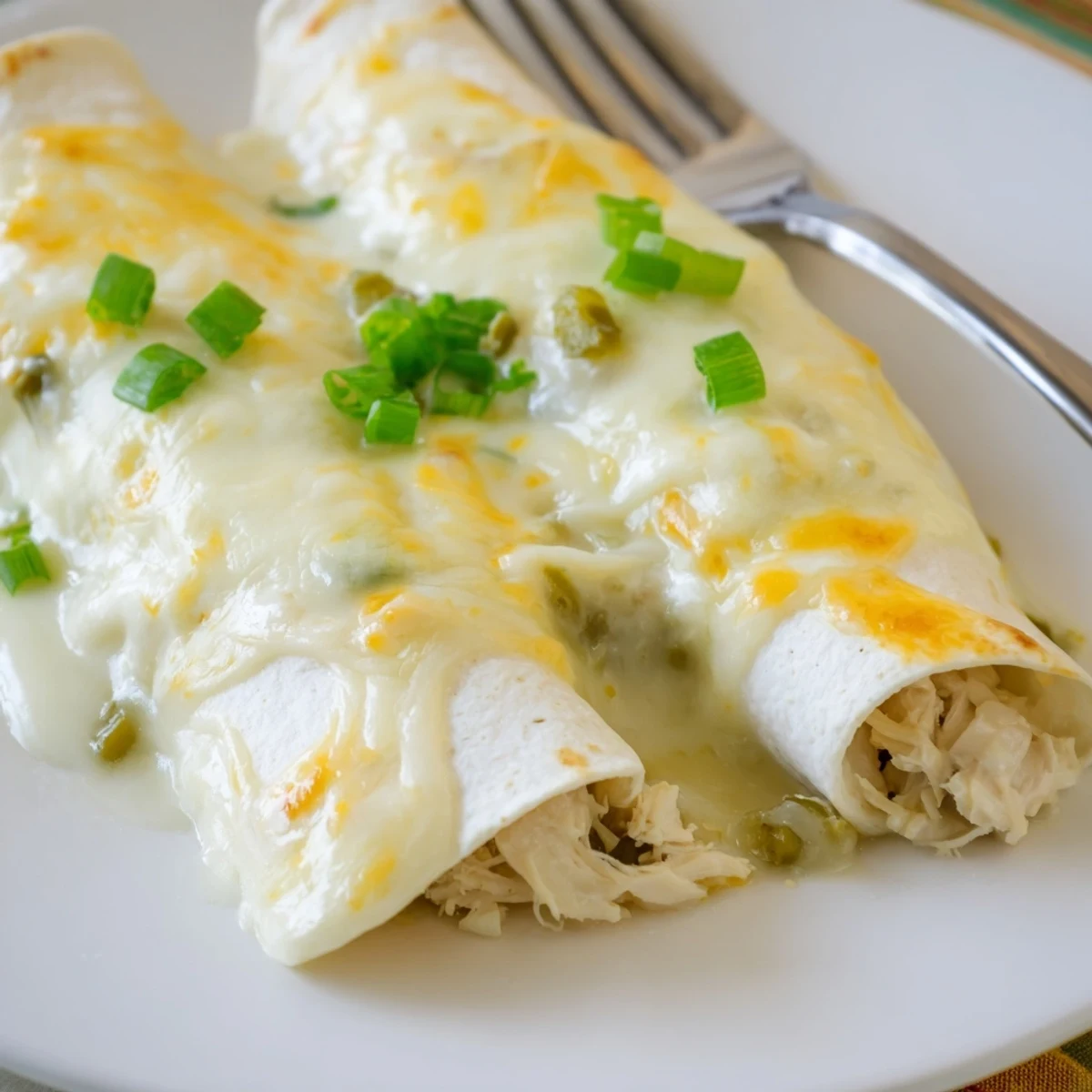 Family style Creamy White Chicken Enchiladas served warm alongside Spanish rice and salad