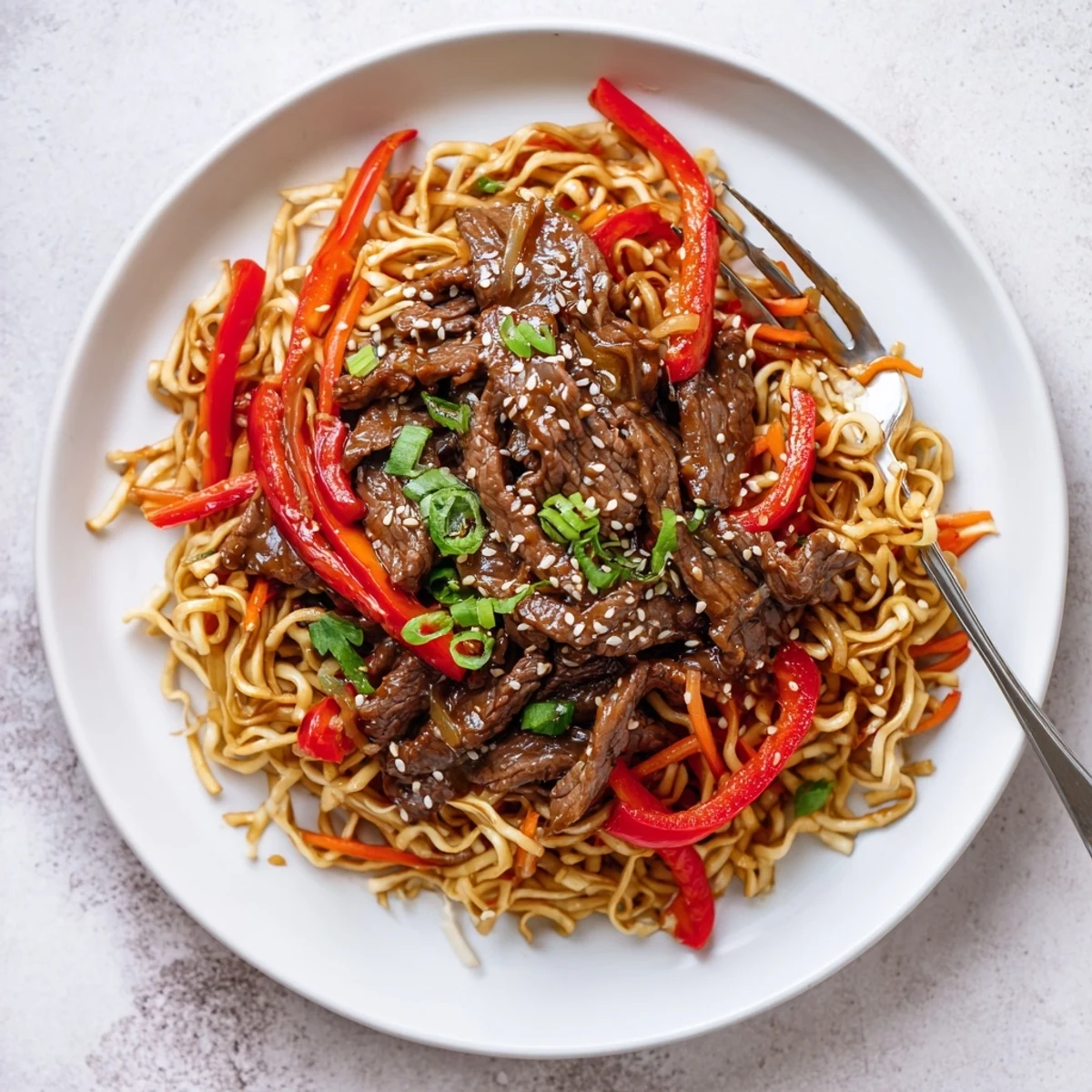 Weeknight Sticky Beef Noodles steaming in wok, glossy honey soy coating, fragrant