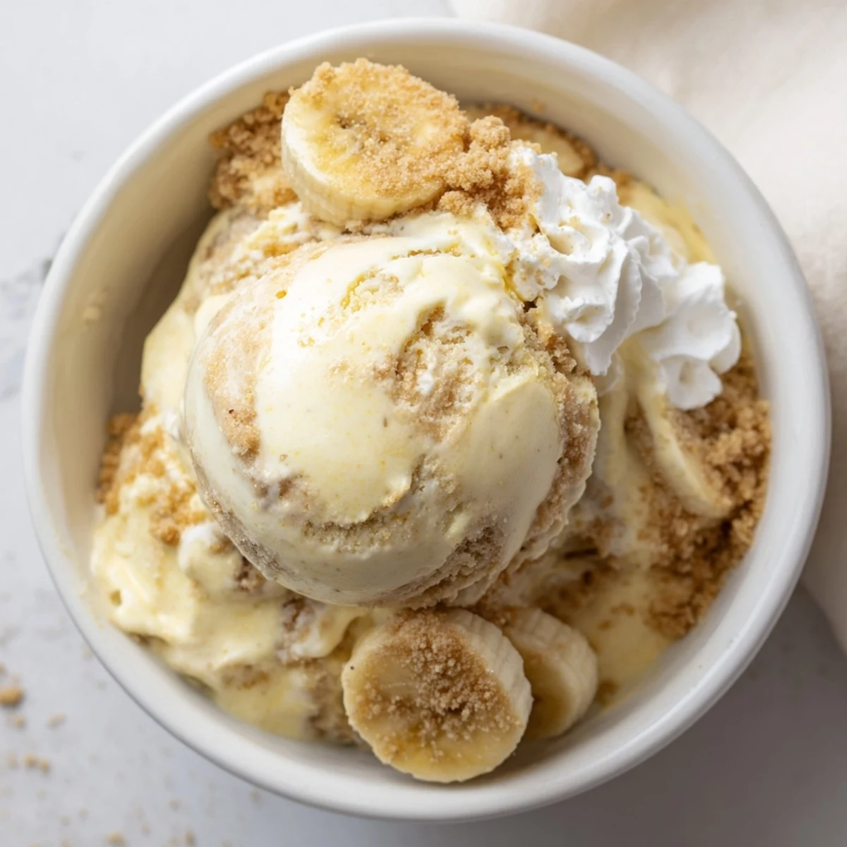 Ninja Creami Banana Cream Pie Ice Cream scoops with graham swirl and whipped cream