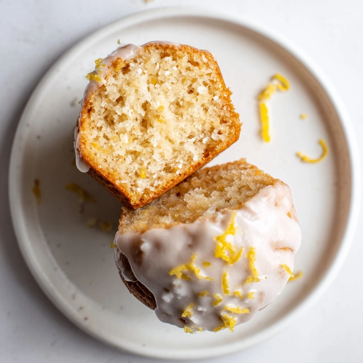 Glazed Lemon Ginger Muffins cooling on a wire rack, lemon glaze glistening  