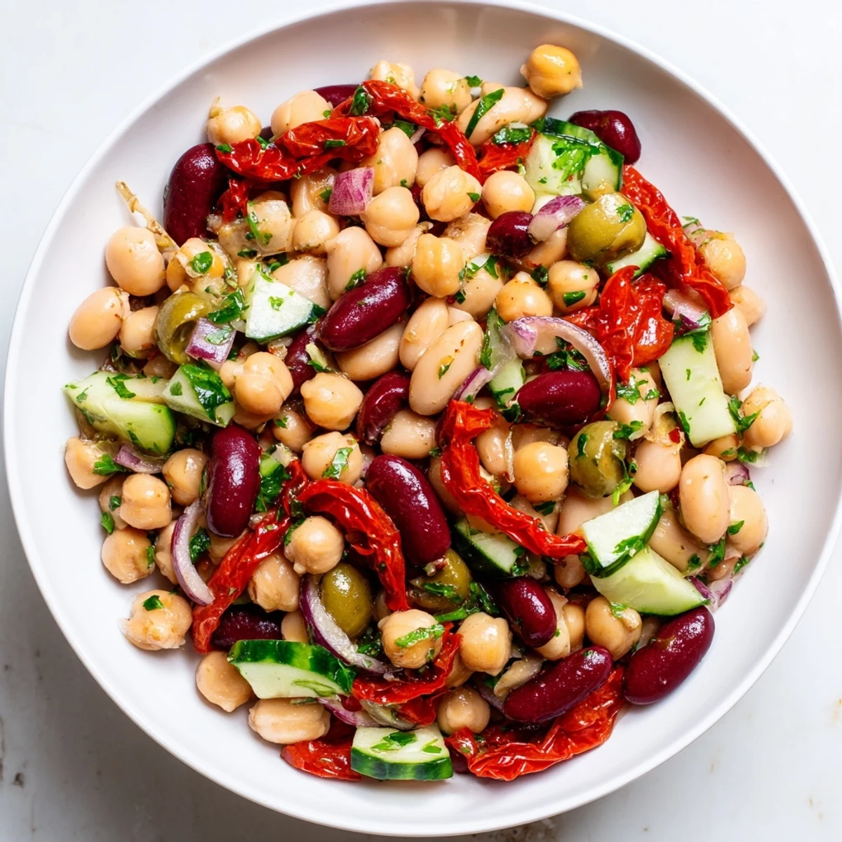 Dense Bean Salad With Sun Dried Tomatoes piled in bowl, bright tangy bites  