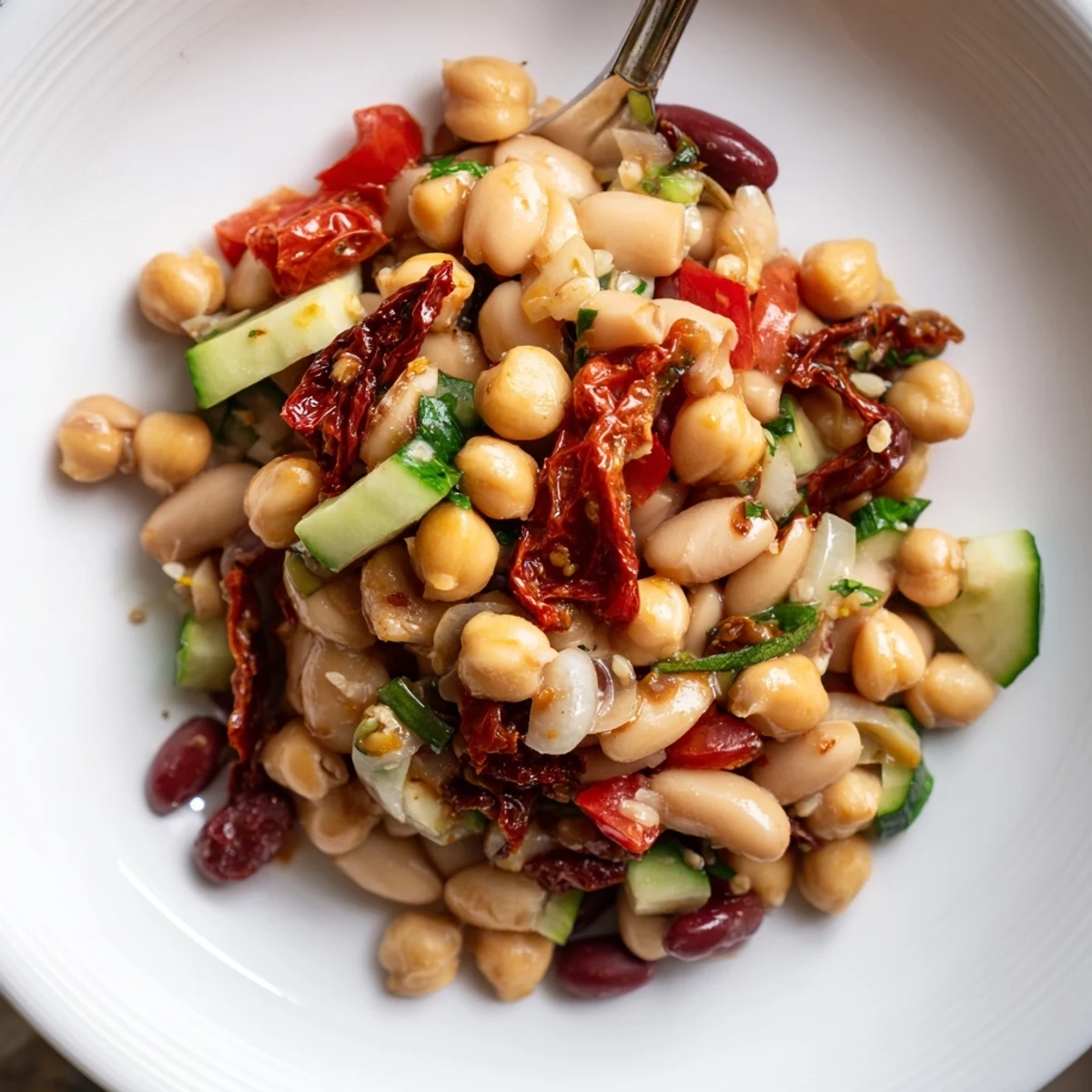 Chilled Dense Bean Salad With Sun Dried Tomatoes served with crusty bread, herbaceous finish