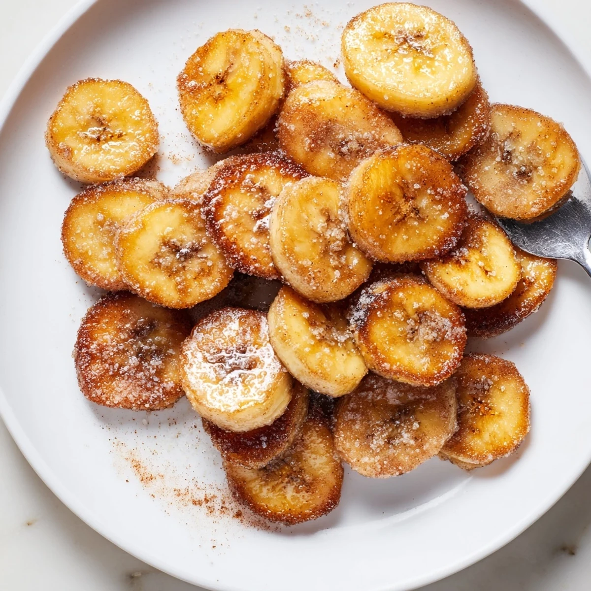 Warm Crispy Cinnamon Sugar Air Fryer Banana Chips with visible golden crunchy edges