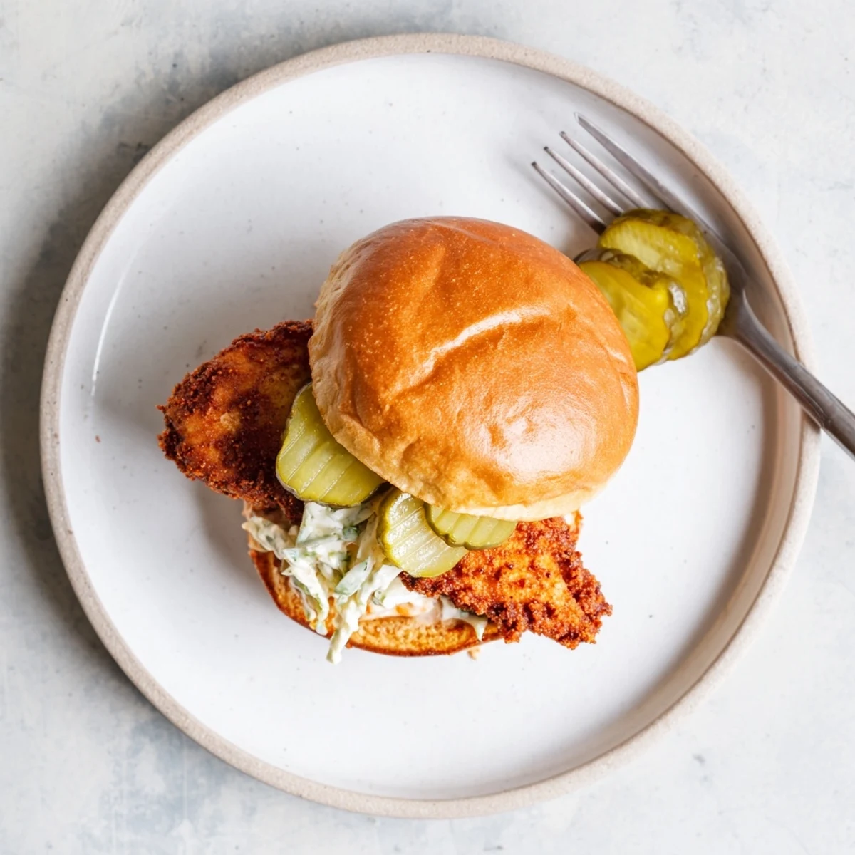 Crispy, fiery Spicy Nashville Hot Chicken Sandwiches served with cold dill pickles, iced tea