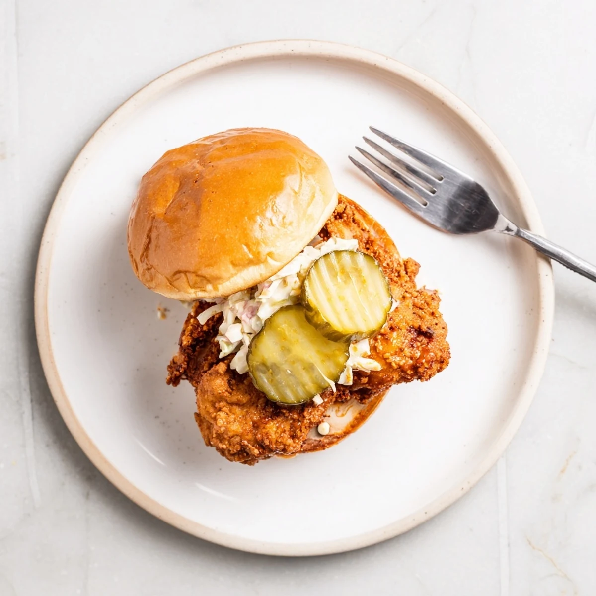 Spicy Nashville Hot Chicken Sandwiches with glossy cayenne glaze, crunchy pickles and slaw