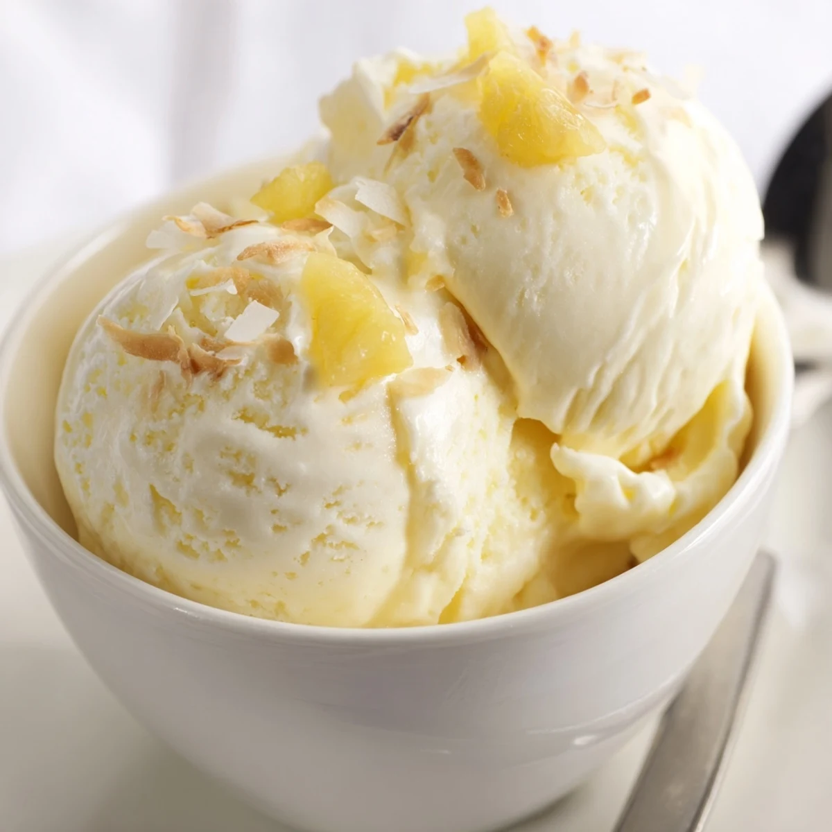 Chilled Creamy Pineapple Ice Cream served with fresh pineapple slices and mint.