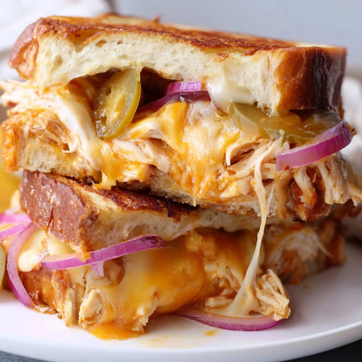 Golden BBQ chicken grilled cheese sandwich with melted cheddar and sourdough bread