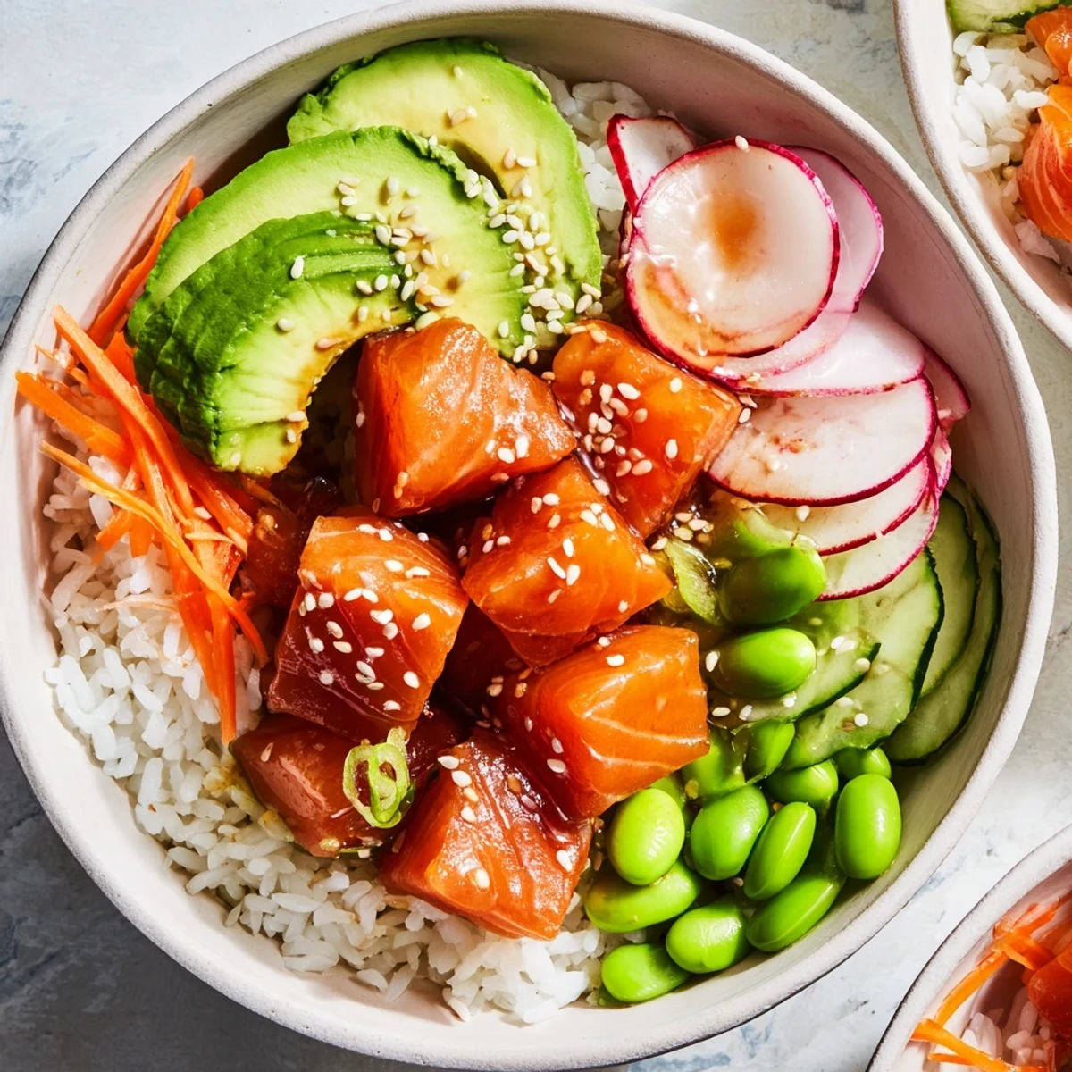 Fresh salmon and avocado poke bowl drizzled with savory sauce over fluffy rice