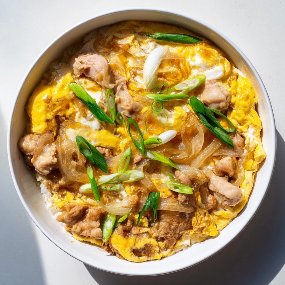 Golden one pot Oyakodon with fluffy rice, tender chicken, and soft-set eggs in savory sauce