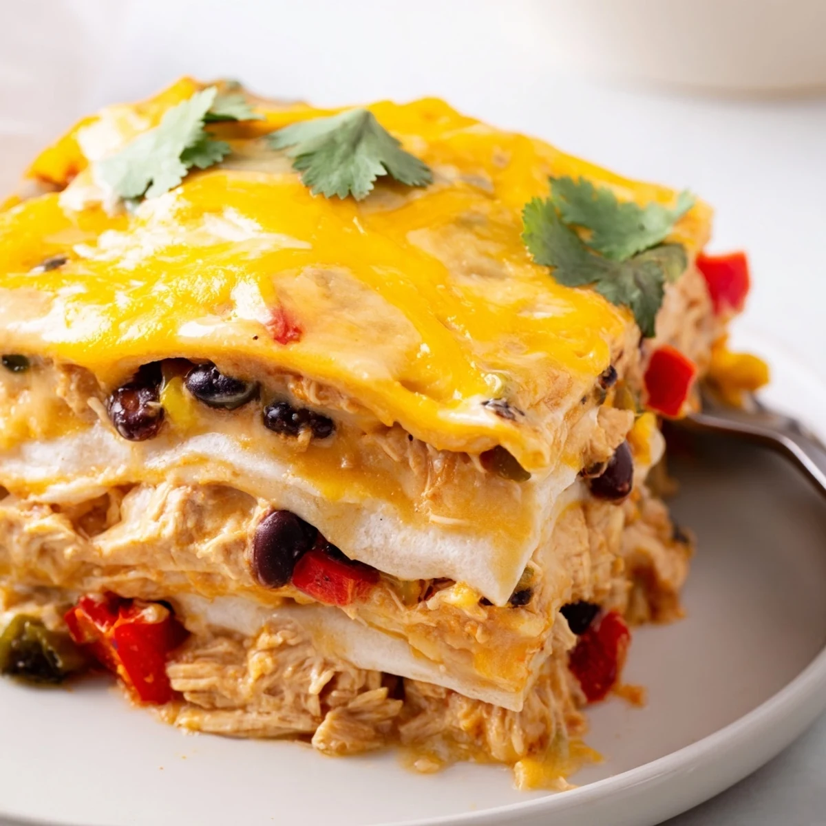 Golden bubbly creamy chicken taco lasagna fresh from the oven with melted cheddar