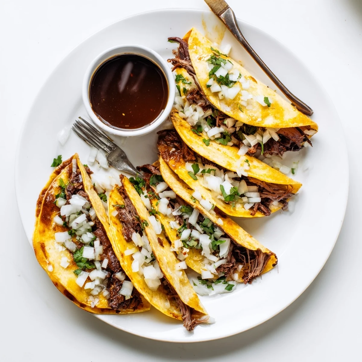 Golden crispy Birria Tacos stuffed with tender shredded beef and melted Oaxaca cheese