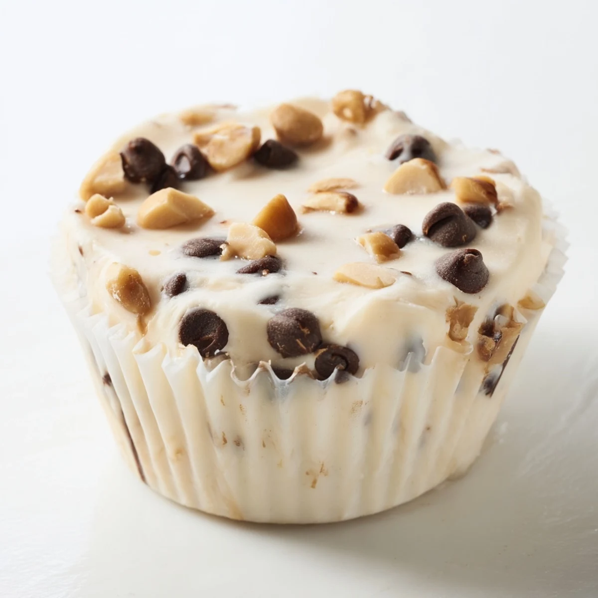 Frozen peanut butter Greek yogurt bites arranged in a muffin tin with chocolate chip toppings