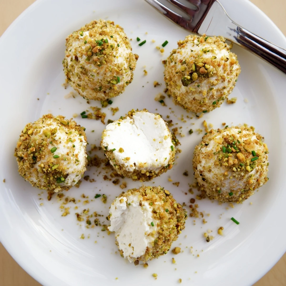 Savory Pistachio Crusted Cheese Bites arranged on platter, crunchy nutty exterior.