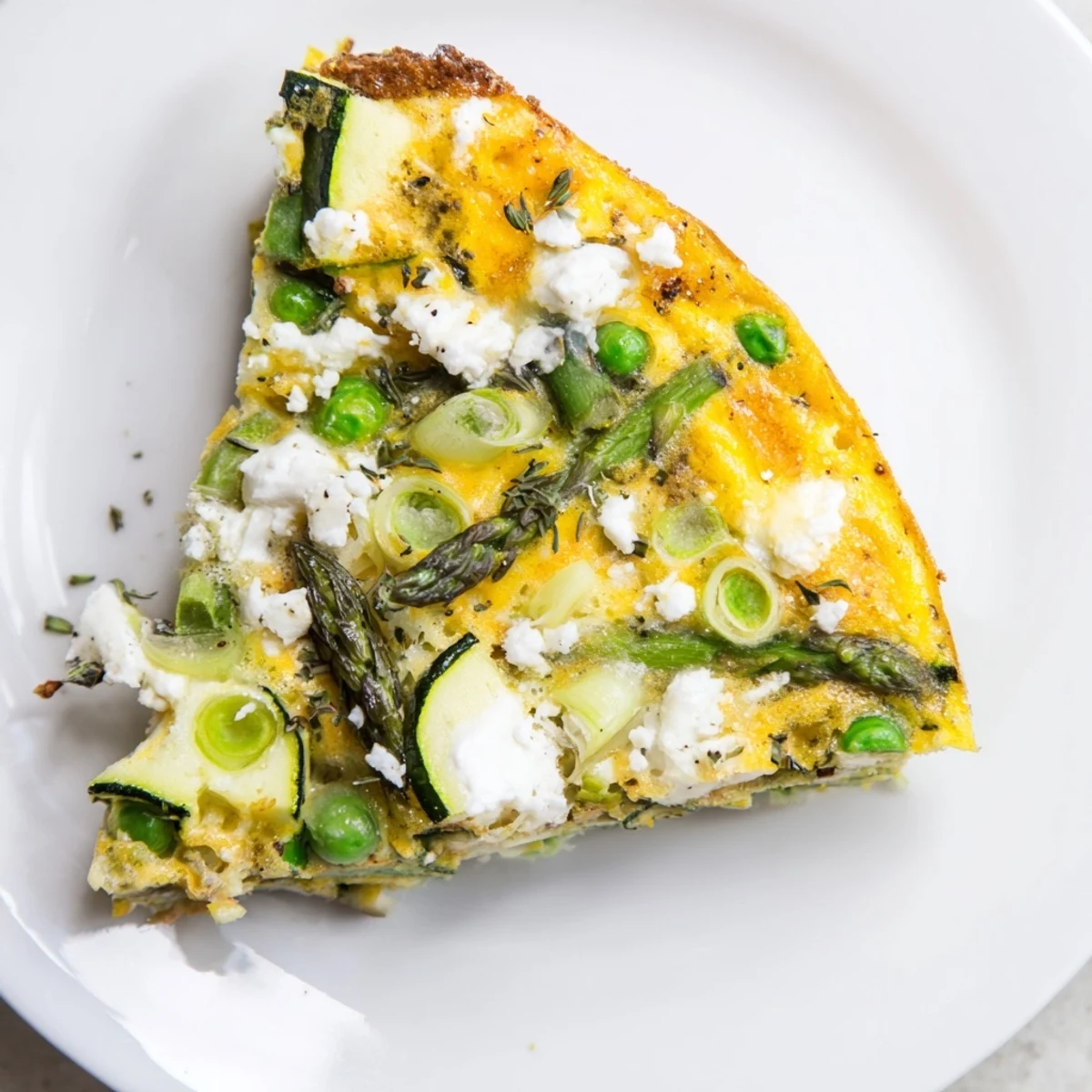 Spring Vegetable Frittata With Goat Cheese, golden top, tender asparagus and zucchini