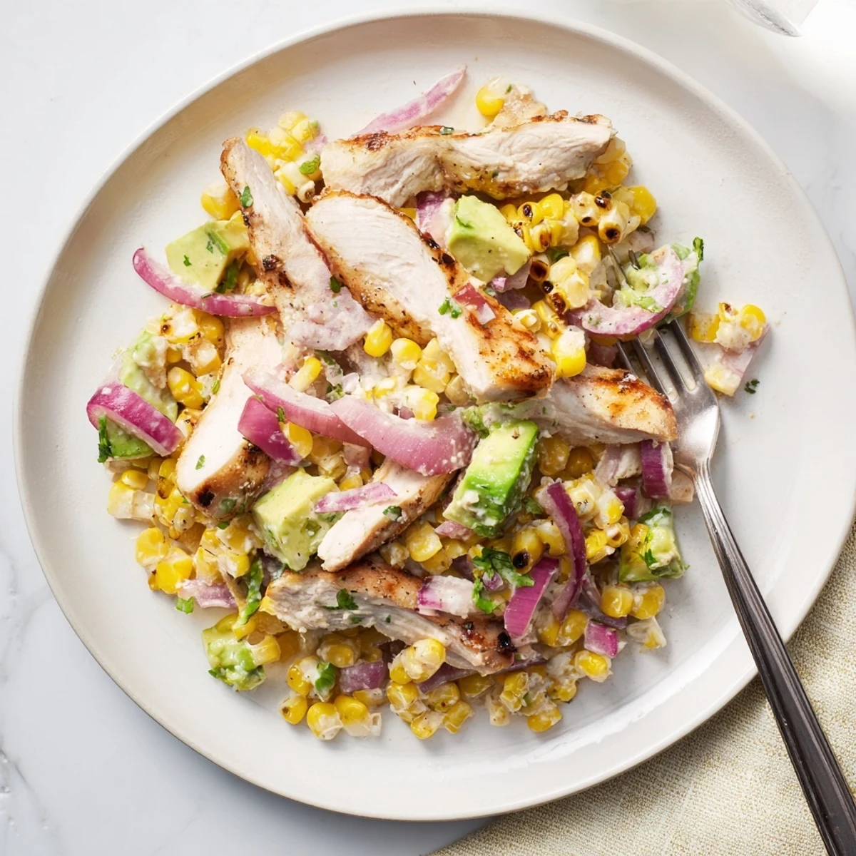 Close up of Mexican chicken street corn salad topped with cotija cheese fresh cilantro lime dressing.