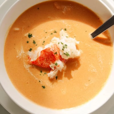 Velvety creamy crab and shrimp bisque served with crusty bread for dipping